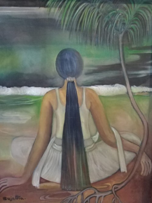 Village girl sitting on the beach