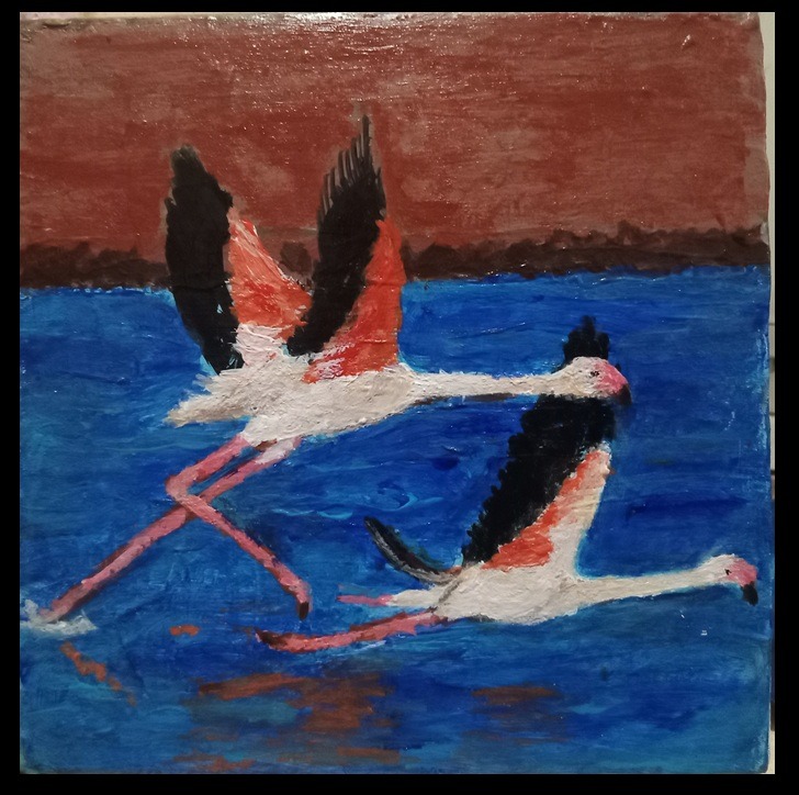 Pair Of Flamingo Flying Over The Water